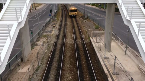 4k Top view of a yellow train arriving at its stop at the station Stock Footage 91748328