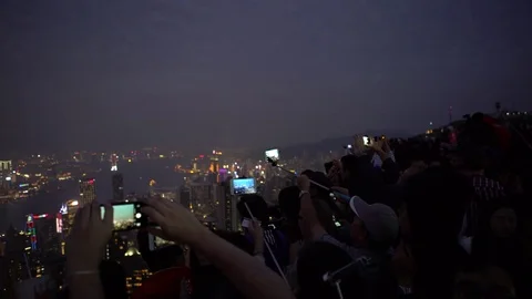 4K Tourist using smart phone take picture in Victoria Peak Hong Kong skyline-Dan Stock Footage 76966413