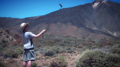 4k Touristic Location Boy Using Selfie Stick Video stock 74944649