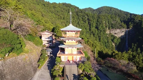 4K Tracking and Tilt-Down Shot of a Red Pagoda near Nachi Falls, Kansai, Japan Stock Footage 257796027