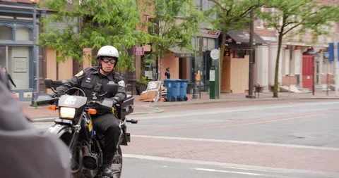 4K TRACKING SHOT OF COPS ON BIKES CLEARING WAY FOR LARGE GROUP OF OFFICERS Stock Footage 132597651