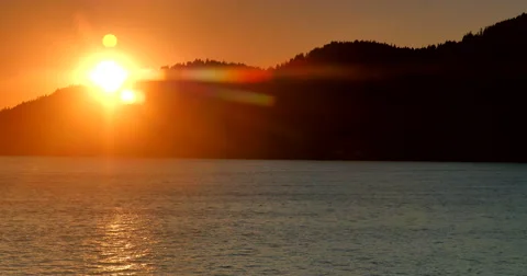 4K Tracking Shot of Sunset Behind Coastal Island Hills Stock-Footage 47008949