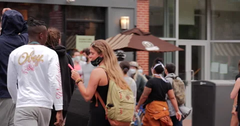 4K TRACKING SHOT TWO MEN JOINING FEMALE FRIENDS IN BLACK LIVES MATTER PROTEST Stock Footage 132597299