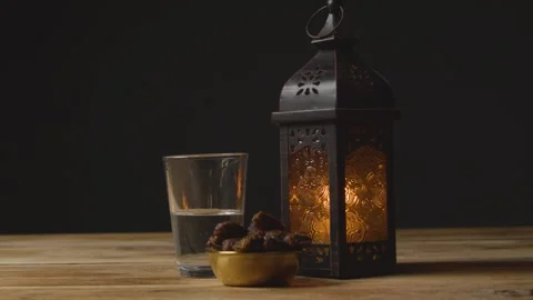 4K Traditional Ramadan Fast Breaking Scene Fanoos Lantern Dates Water Stock Footage 334466347
