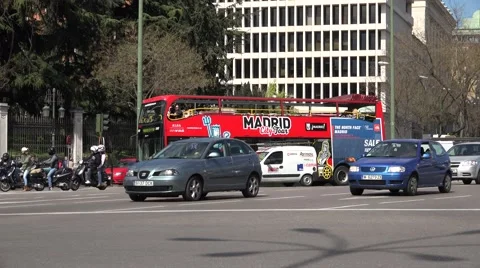 4K Traffic car street intersection touristic red bus Madrid town people commute  Stock Footage 61423595