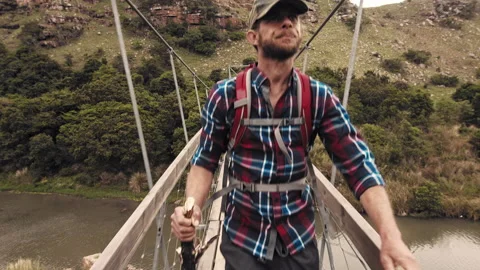 4k of trekker walking with walking stick on wood sespention footbridge on walkin 動画素材 199621064