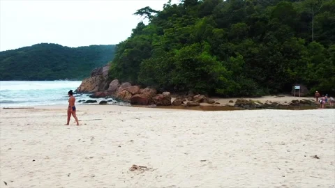 4K Trindade Brazil Girl Walking Aerial Side Drone Shot Stock Footage