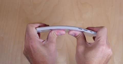 4K Trying to Bend an iPhone 6 Plus Stock Footage 42598886