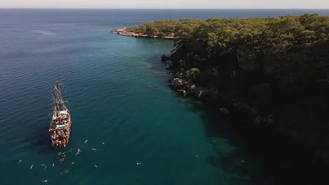 4K turquoise mediterranean sea, commercial trip boat, people swimming in the sea Stock Footage 263095853