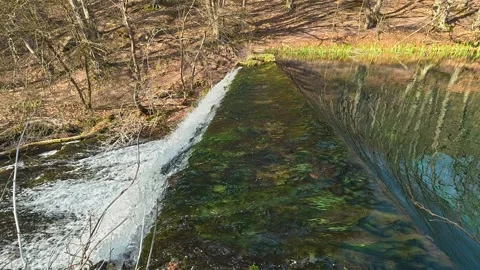 4K Turquoise Water Cascading Over Dam - Emerald River Overflow Video stock 332373431
