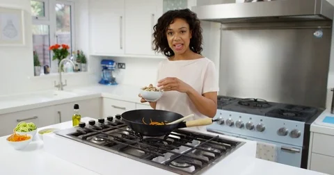 4K TV presenter on a cookery show preparing a healthy meal &amp; talking to camera Stock Footage 75243549