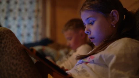4K Two children playing their portable devices Video stock 106732406
