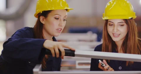 4K Two female engineers carrying out a service check on factory machinery Stock Footage 102008106
