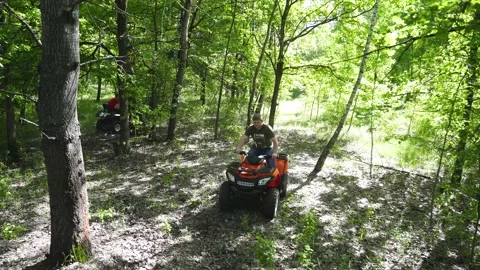 4K Two guys on ATVs make a U-turn among the trees in the forest. Stock Footage 139884580
