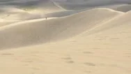 4K Two Hikers On Wind Blown Sand Dunes Stock Footage