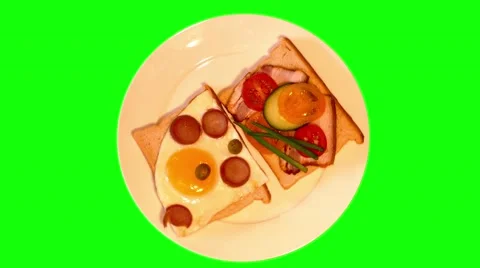 4k two opened sandwiches with bacon, sausages, egg and vegetables on plate Stock Footage 49610740