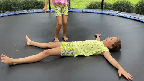 4k Two small girls jumping on a trampoline. Stock Footage 158533233
