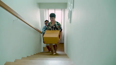 4K, Two young Asian men, who are in love with each other, Helping to carry lo Stock Footage 201617196