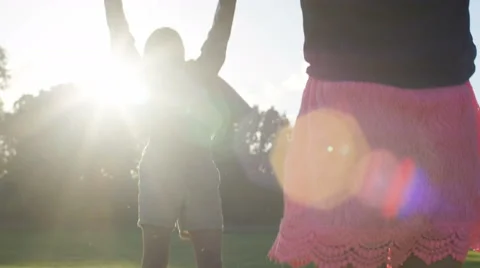 4K Two young children spreading a blanket onto the grass Stock Footage 64754943