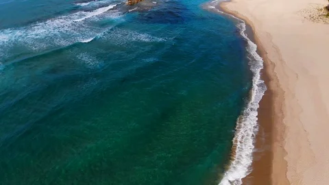 4k UHD 45 degrees aerial view of waves motion over sea rocks,transparent ground Stock Footage 104456161