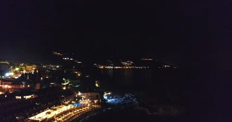 4K UHD Aerial Rises above the night city near the sea overlooking the Stock Footage 101445906