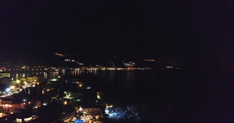 4K UHD Aerial Rises above the night city near the sea overlooking the Stock Footage 101445983
