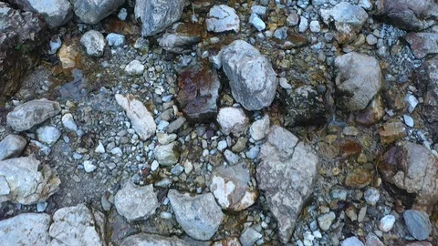 4K UHD Aerial view of tiny cold water mountain stream flowing between a stones i Stock-Footage 121756772