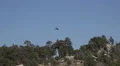 4K UHD blackhawk flies over trees mountain dissapears 4k or 4k+ Resolution