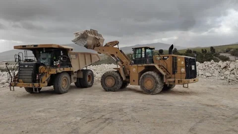 4K UHD: Caterpillar Wheel Loader Loading CAT Dump Truck in Quarry Stock Footage 331890285