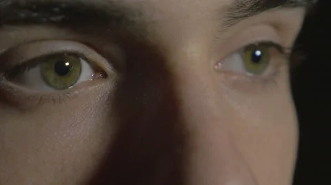 4k UHD - Close-up of a young man eyes in the dark Stock Footage 46741500