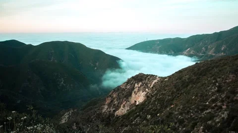 4k UHD Clouds moving out of mountains Video stock 65203541