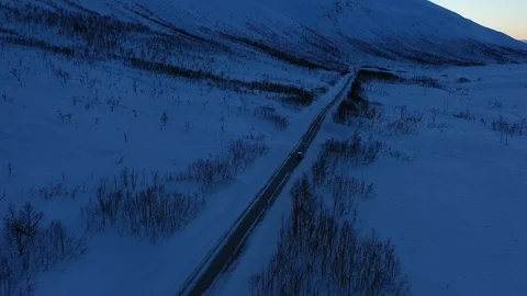 4K-UHD Drone Shot: flying over snowy road in Norway Stock Footage