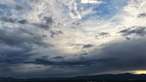 4K UHD Drone Timelapse: Moody Shifting Storm Clouds Over Dark Mountain Range At Stock Footage 337727396
