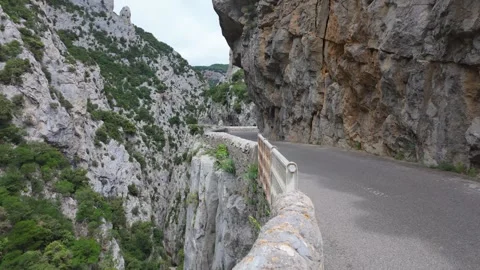4K UHD dynamic handheld shot driving along narrow mountain cliff road Stock-Footage 347140619