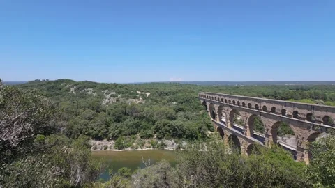 4K UHD dynamic panning shot of historic stone aqueduct over river valley Stock-Footage 347126406