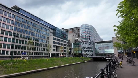 4K UHD dynamic panning shot of modern Utrecht canal with buildings Vídeos de archivo 347200873