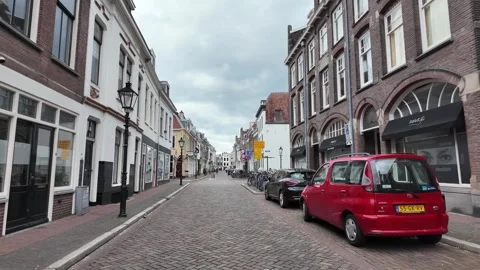 4K UHD dynamic tracking shot of Utrecht street with bicycles and cars Stockbeeldmateriaal 347200709