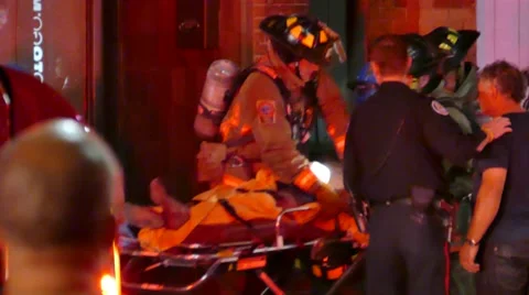 4K UHD - Emergency crews doing CPR while moving stretcher Stock Footage 52624744