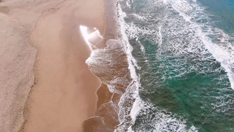 4k uhd epic aerial view zoom in out from multicolored waves motion on a beach Stock Footage 104028951