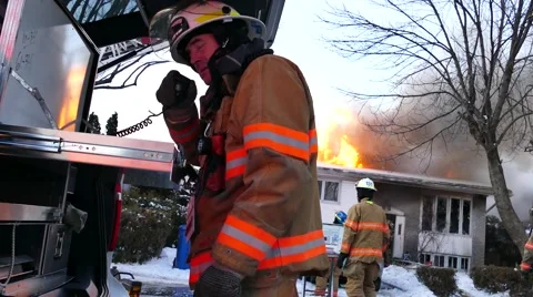 4K UHD - Fire captain speaking on radio at command post with flames Video stock 46519888
