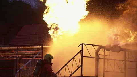 4k UHD Firefighter using water fog type fire extinguisher to fighting with th Stock Footage 146883930