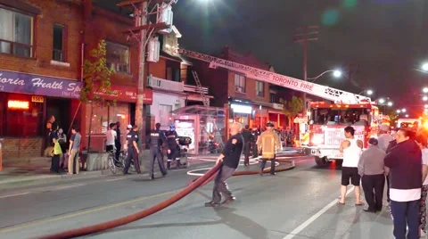 4K UHD - Fireman moving large hose with CPR in background Stock Footage 52624613