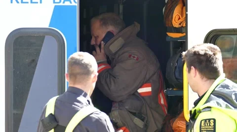 4K UHD - Fireman talking on cellphone in the back of ambulance Stock Footage 51712252