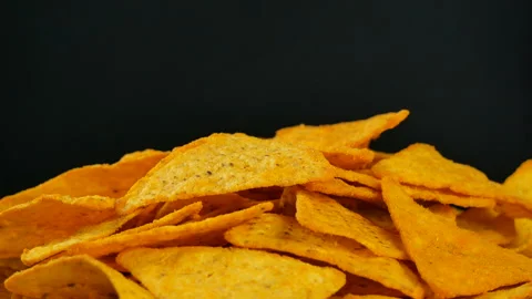 4K UHD footage of triangle nacho chips slowly rotating, close up Stock Footage 86406033