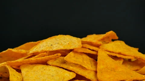 4K UHD footage of triangle nacho chips slowly rotating, close up Stock Footage 86407880