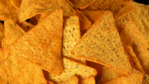 4K UHD footage of triangle nacho chips slowly rotating, close up Stock Footage 86408415