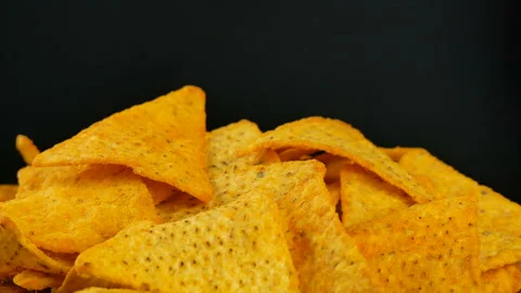 4K UHD footage of triangle nacho chips slowly rotating, close up Stock Footage 86408638