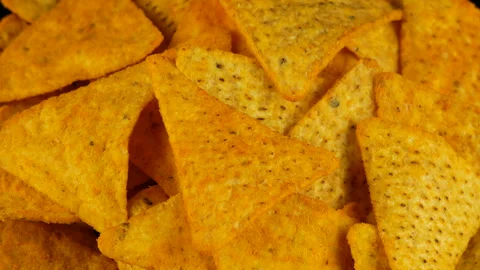 4K UHD footage of triangle nacho chips slowly rotating, close up Stock Footage 86409272