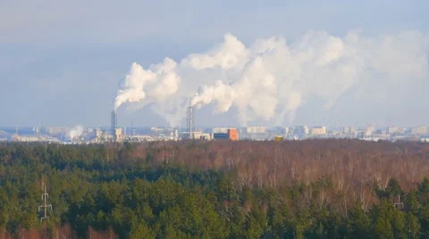 4K UHD Industrial factory with chimneys and smoke beyond the forest Stock Footage 59168636