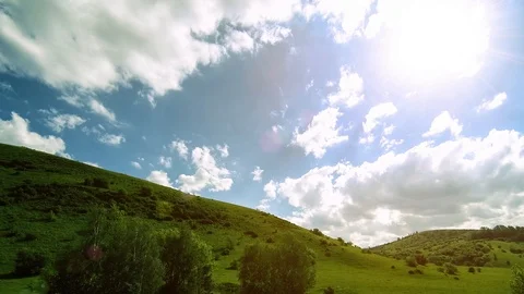 4K UHD mountain meadow timelapse at the summer. Clouds, trees, green grass and Stock Footage 127386320